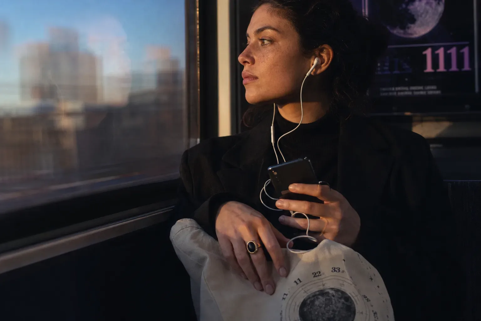 Commuter listening softly beside a morning train window