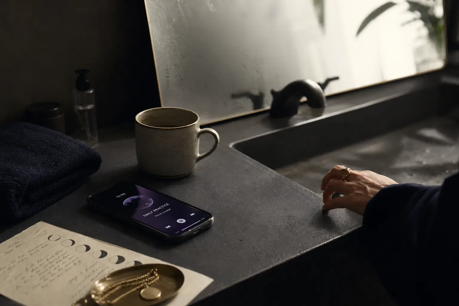 Person listening to morning audio beside a sink