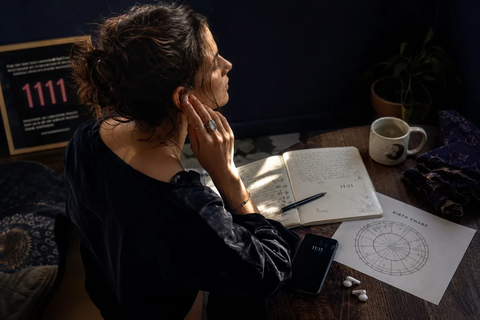 Woman listening to audio beside a birth chart