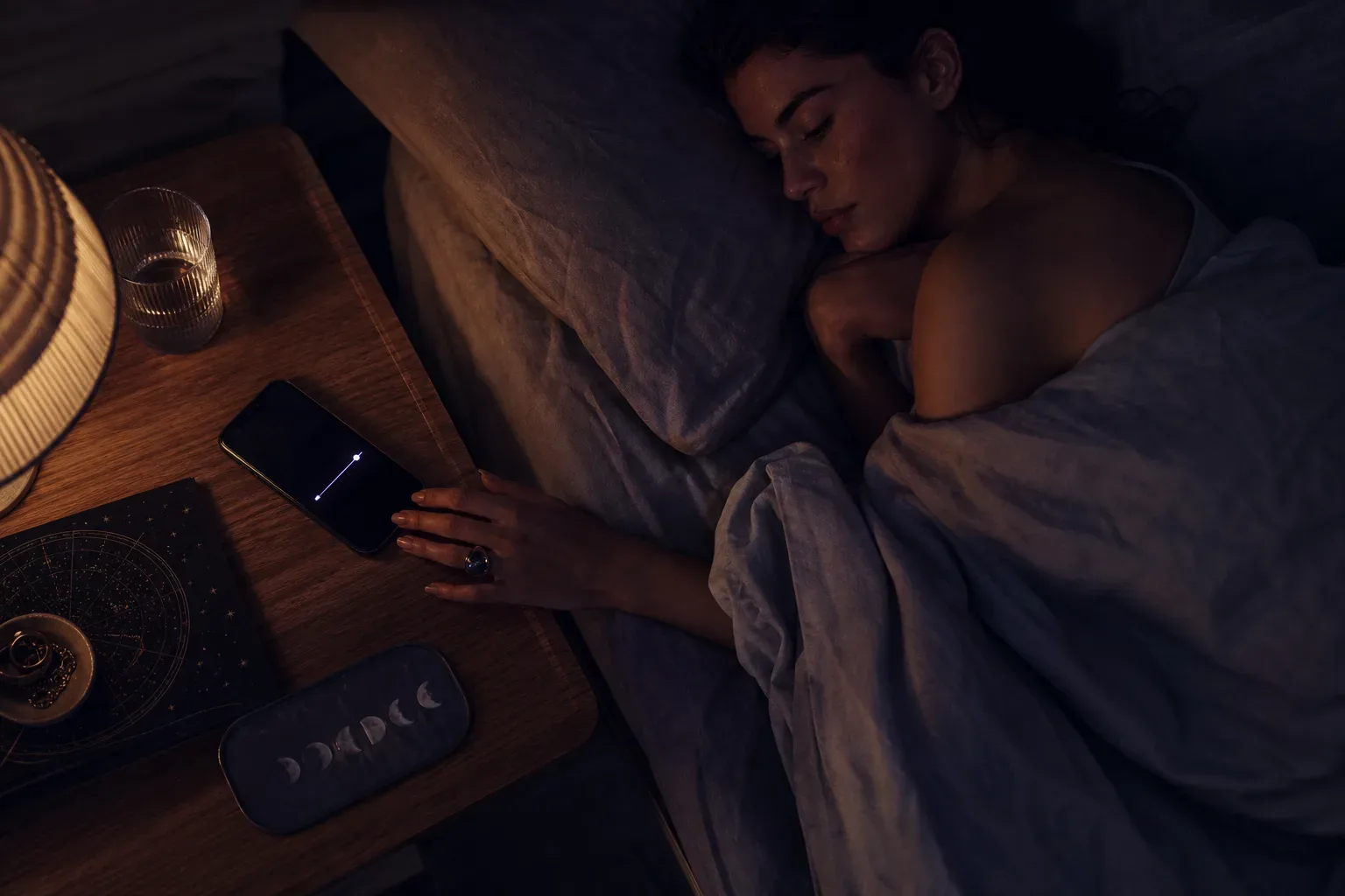 Woman listening to quiet audio before sleep
