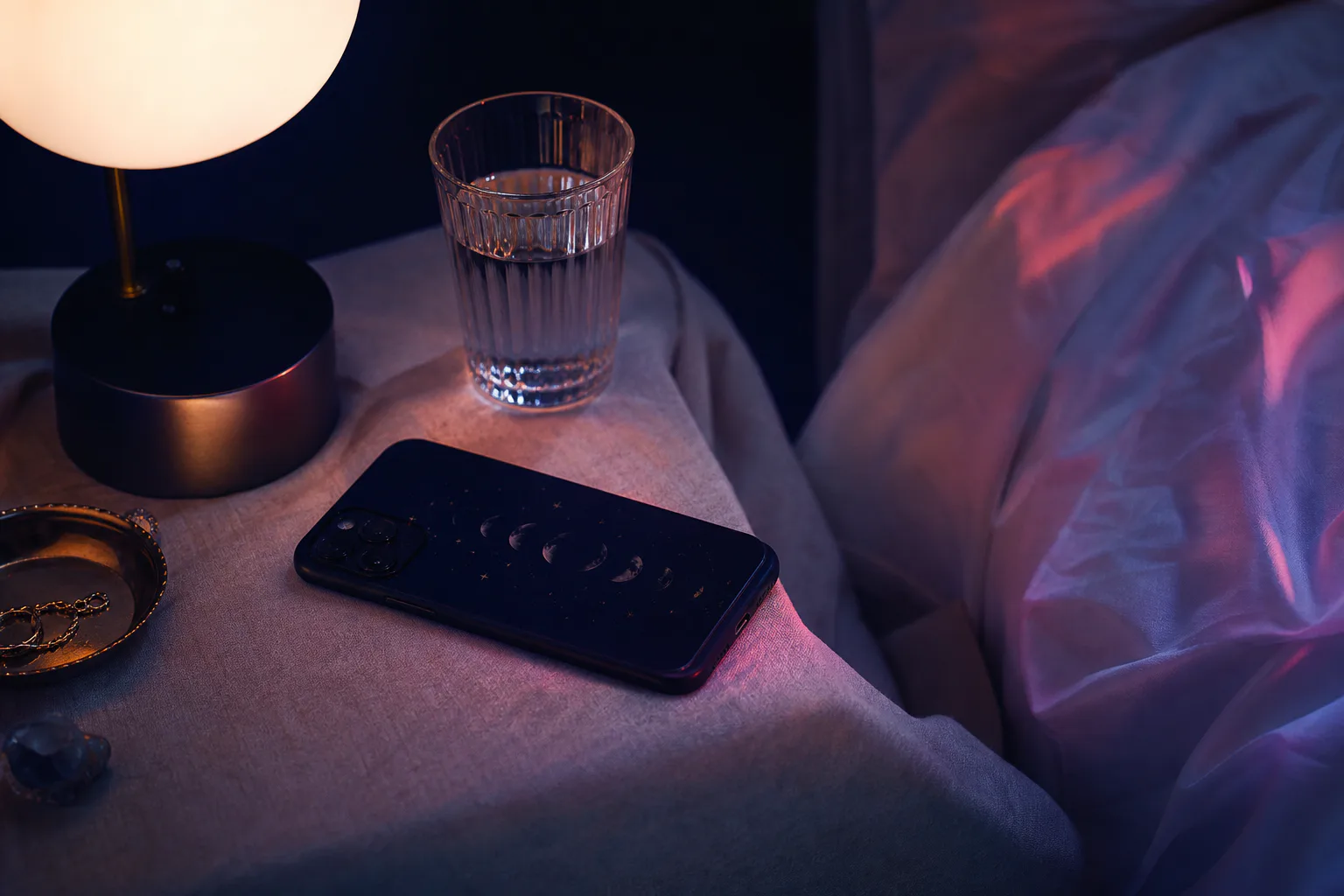 Phone beside bed playing quiet nighttime audio